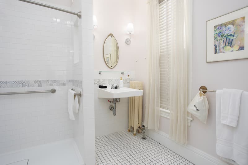 well-lit bathroom with toiletries and hairdryer