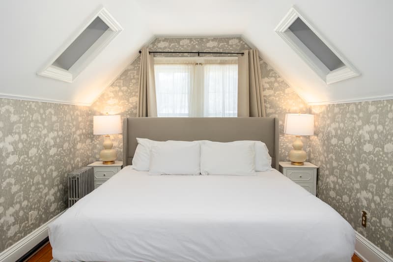 spacious room with king bed and large rugs throughout