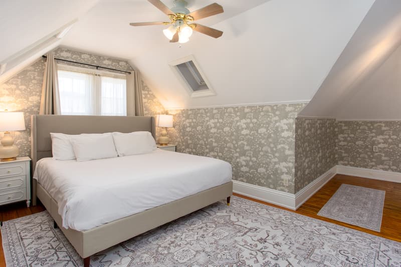 spacious room with king bed and large rugs