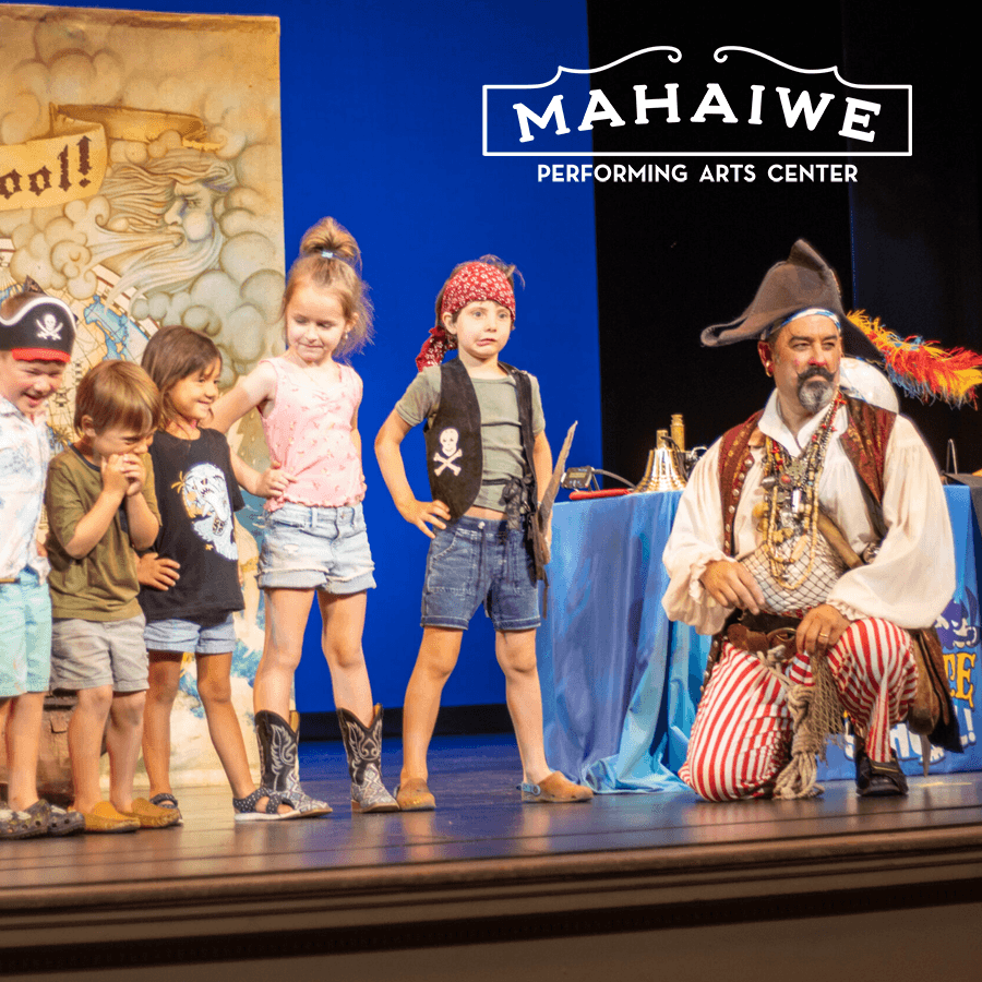 A group of children dressed in pirate costumes stand on stage with an adult pirate performer at the Mahaiwe Performing Arts Center.